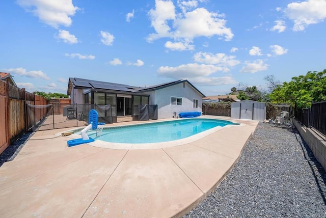 7971 Jade Coast Rd, San Diego, CA 92126 - view of swimming pool with a sunroom, a storage shed, a patio area, and a fenced backyard