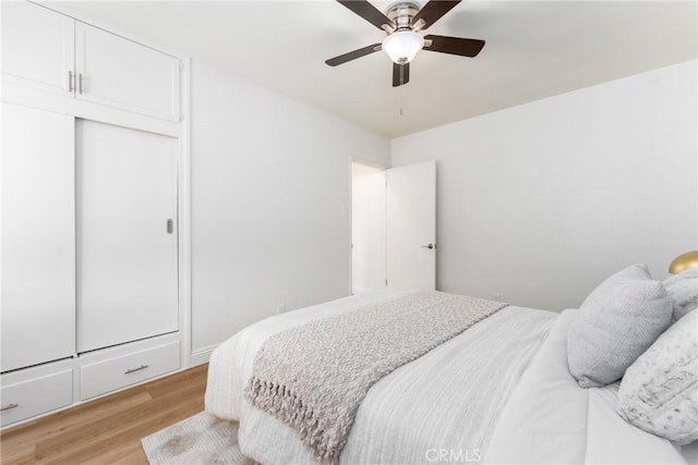 2283 Gaviota Ave, Signal Hill, CA 90755 - bedroom with light wood-style floors, a closet, and a ceiling fan