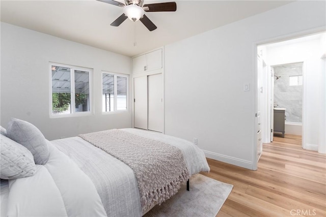 2283 Gaviota Ave, Signal Hill, CA 90755 - bedroom featuring multiple windows, light wood-style flooring, a closet, and a ceiling fan