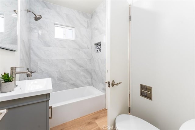 2283 Gaviota Ave, Signal Hill, CA 90755 - bathroom with vanity, washtub / shower combination, and wood finished floors