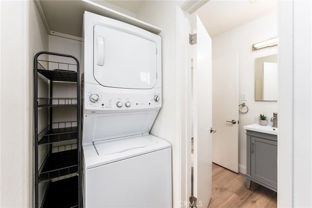2283 Gaviota Ave, Signal Hill, CA 90755 - laundry room featuring stacked washing machine and dryer and light wood-type flooring