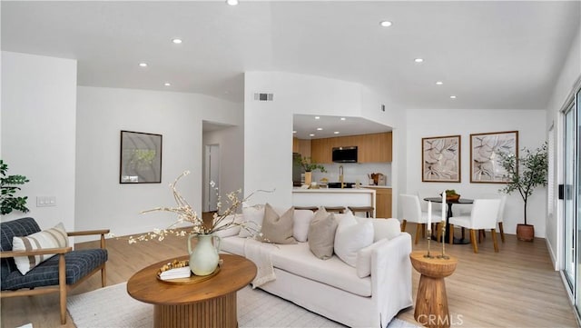 19081 Wildwood Cir, Lake Forest, CA 92679 - living area with lofted ceiling, light wood-style floors, and recessed lighting