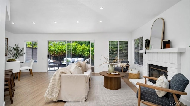 19081 Wildwood Cir, Lake Forest, CA 92679 - living room featuring light wood-type flooring, recessed lighting, and a fireplace