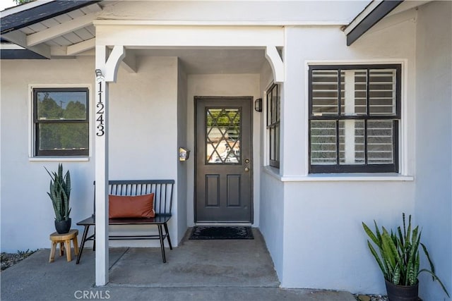 11243 Gaviota Ave, Granada Hills, CA 91344 - doorway to property with stucco siding and covered porch