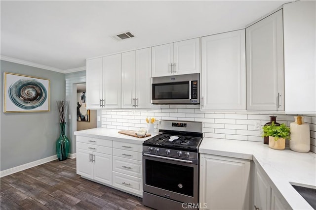 11243 Gaviota Ave, Granada Hills, CA 91344 - kitchen with appliances with stainless steel finishes, white cabinets, tasteful backsplash, crown molding, and dark wood-style floors