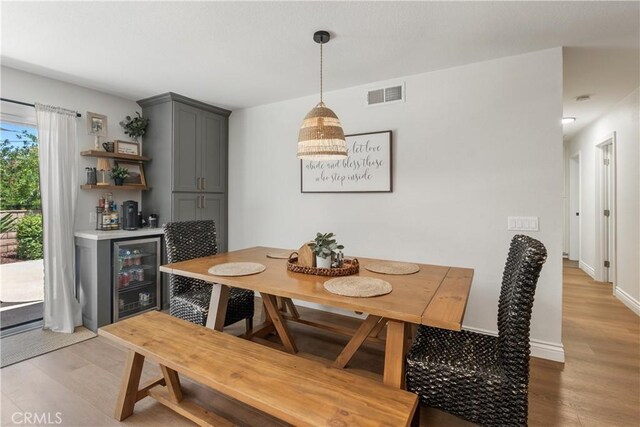 2151 Stonefield Pl, Riverside, CA 92506 - dining space featuring a bar, light wood finished floors, and beverage cooler
