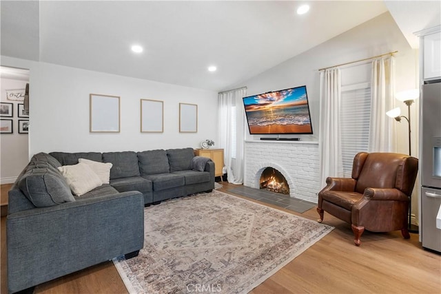 2151 Stonefield Pl, Riverside, CA 92506 - living room with light wood finished floors, a brick fireplace, recessed lighting, and lofted ceiling