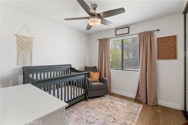 2151 Stonefield Pl, Riverside, CA 92506 - bedroom featuring wood finished floors, a nursery area, and ceiling fan