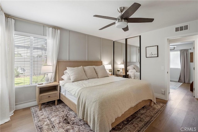 2151 Stonefield Pl, Riverside, CA 92506 - bedroom with multiple windows, light wood-style flooring, ceiling fan, and a closet
