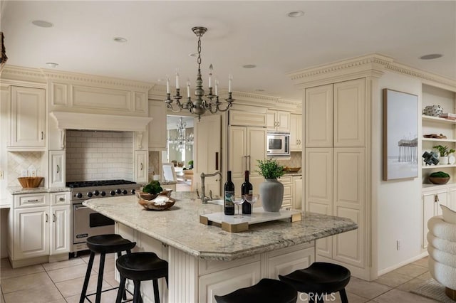 816 Via Lido Nord, Newport Beach, CA 92663 - kitchen featuring appliances with stainless steel finishes, a chandelier, light tile patterned flooring, a kitchen breakfast bar, and backsplash