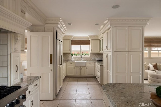 816 Via Lido Nord, Newport Beach, CA 92663 - kitchen featuring healthy amount of natural light, light stone countertops, tasteful backsplash, stove, and recessed lighting