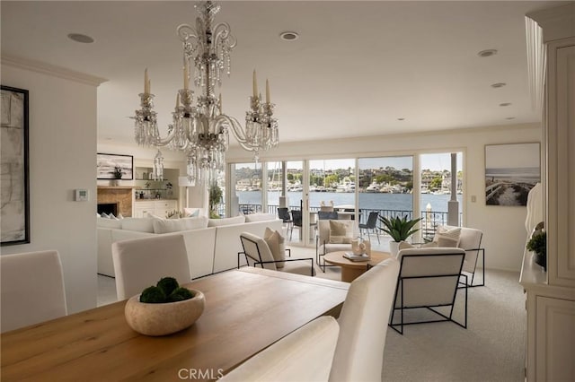 816 Via Lido Nord, Newport Beach, CA 92663 - carpeted dining area with a chandelier, a water view, ornamental molding, and recessed lighting