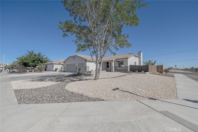 11490 Autumn St, Adelanto, CA 92301 - single story home featuring concrete driveway, a garage, and a chimney