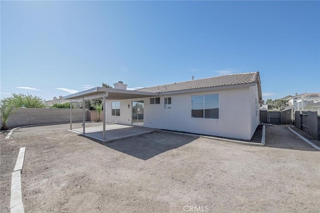 11490 Autumn St, Adelanto, CA 92301 - back of property featuring a patio, a fenced backyard, stucco siding, and a tiled roof