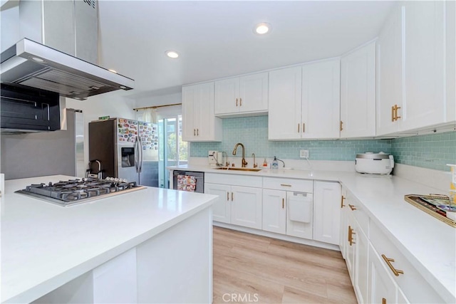 358 S Gramercy Pl Unit 201, Los Angeles, CA 90020 - kitchen with stainless steel appliances, exhaust hood, light countertops, white cabinets, and recessed lighting