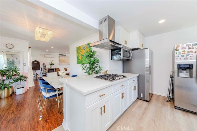 358 S Gramercy Pl Unit 201, Los Angeles, CA 90020 - kitchen with appliances with stainless steel finishes, island range hood, light wood-type flooring, white cabinets, and recessed lighting