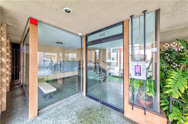358 S Gramercy Pl Unit 201, Los Angeles, CA 90020 - doorway to property with a surveillance system and stucco siding