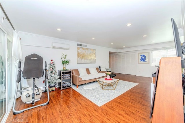 358 S Gramercy Pl Unit 201, Los Angeles, CA 90020 - living room featuring a wall mounted AC, wood finished floors, crown molding, and recessed lighting