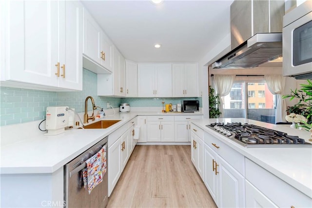 358 S Gramercy Pl Unit 201, Los Angeles, CA 90020 - kitchen with stainless steel appliances, light countertops, backsplash, light wood finished floors, and white cabinets