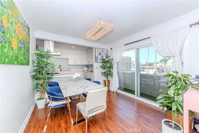 358 S Gramercy Pl Unit 201, Los Angeles, CA 90020 - dining area with wood finished floors and ornamental molding
