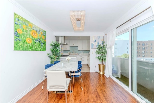 358 S Gramercy Pl Unit 201, Los Angeles, CA 90020 - dining room with light wood finished floors and ornamental molding