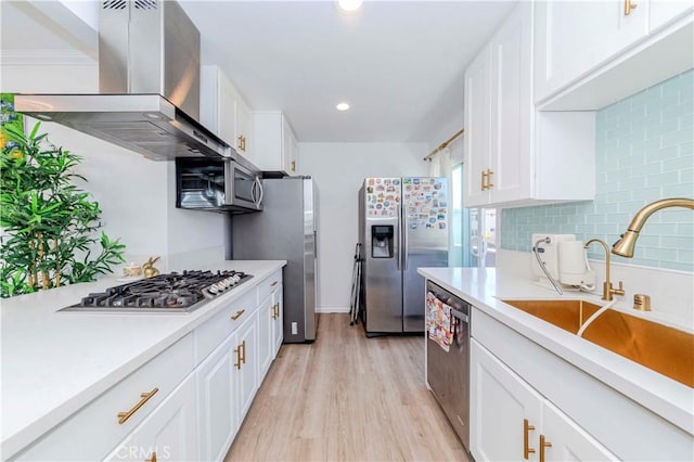 358 S Gramercy Pl Unit 201, Los Angeles, CA 90020 - kitchen with island range hood, stainless steel appliances, decorative backsplash, light countertops, and white cabinetry