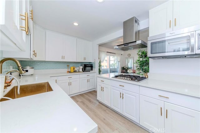 358 S Gramercy Pl Unit 201, Los Angeles, CA 90020 - kitchen with range hood, appliances with stainless steel finishes, light countertops, white cabinetry, and recessed lighting