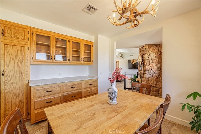 14320 Kiptree Dr, Lake Hughes, CA 93532 - dining space featuring a chandelier and baseboards