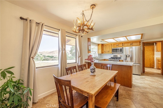 14320 Kiptree Dr, Lake Hughes, CA 93532 - dining room featuring a chandelier and light tile patterned flooring