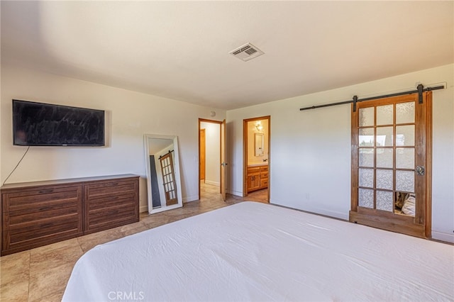 14320 Kiptree Dr, Lake Hughes, CA 93532 - bedroom with a barn door, tile patterned flooring, and connected bathroom
