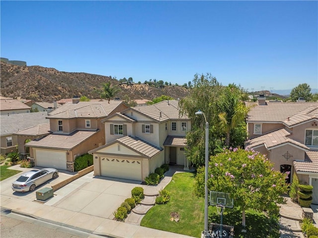 28323 Roman Ct, Saugus, CA 91350 - traditional home with a residential view, concrete driveway, stucco siding, and a front yard