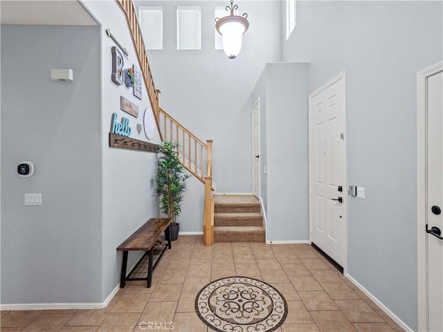 28323 Roman Ct, Saugus, CA 91350 - foyer entrance featuring light tile patterned floors, stairway, and a high ceiling