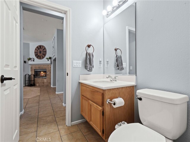 28323 Roman Ct, Saugus, CA 91350 - half bathroom with vanity, tile patterned floors, and a fireplace