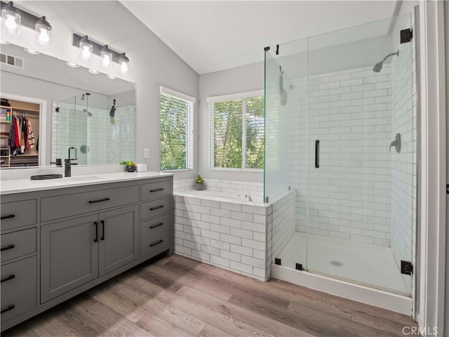 28323 Roman Ct, Saugus, CA 91350 - bathroom featuring lofted ceiling, vanity, a shower stall, wood finished floors, and a spacious closet