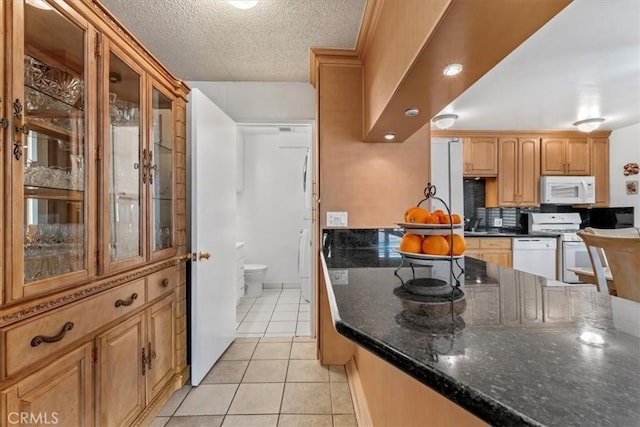 429 E Providencia Ave Unit B, Burbank, CA 91501 - kitchen featuring white appliances, light tile patterned floors, glass insert cabinets, a textured ceiling, and dark stone countertops