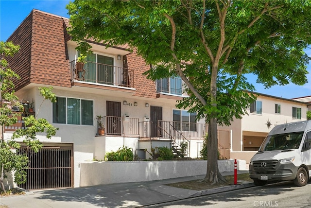 429 E Providencia Ave Unit B, Burbank, CA 91501 - townhome / multi-family property with stucco siding, roof with shingles, mansard roof, and an attached garage