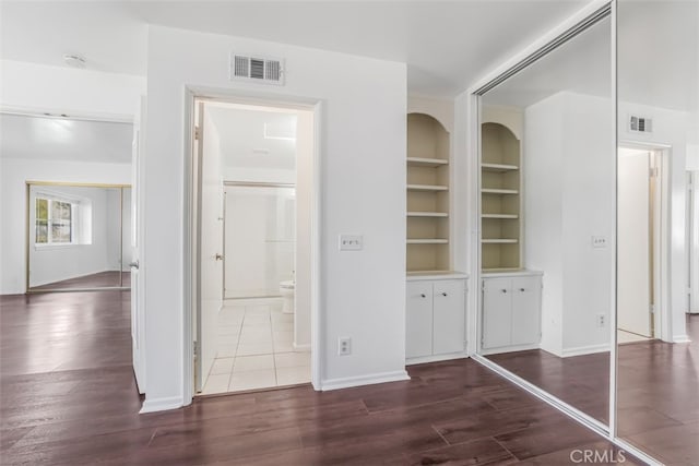 6304 Tamarind St, Oak Park, CA 91377 - hallway featuring dark wood-style floors and built in shelves