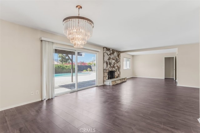 6304 Tamarind St, Oak Park, CA 91377 - unfurnished living room featuring a chandelier, dark wood-style floors, and a fireplace