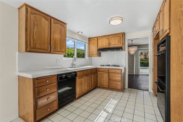 6304 Tamarind St, Oak Park, CA 91377 - kitchen with black appliances, decorative backsplash, and brown cabinetry