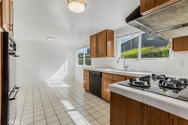 6304 Tamarind St, Oak Park, CA 91377 - kitchen featuring black appliances, ventilation hood, tile counters, backsplash, and brown cabinets