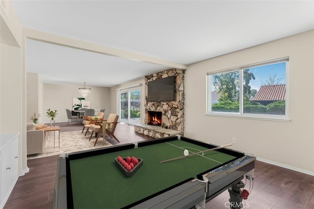 6304 Tamarind St, Oak Park, CA 91377 - game room with dark wood finished floors, healthy amount of natural light, and a stone fireplace