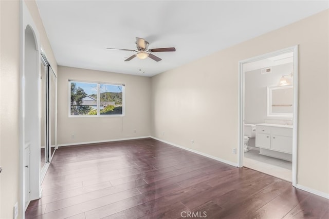 6304 Tamarind St, Oak Park, CA 91377 - unfurnished bedroom with dark wood-style flooring, ensuite bath, arched walkways, a closet, and ceiling fan