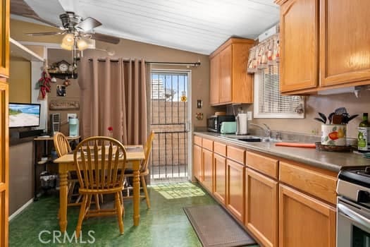 17059 E Groverdale St, Covina, CA 91722 - kitchen featuring lofted ceiling, a ceiling fan, stainless steel appliances, light countertops, and dark flooring