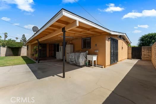 17059 E Groverdale St, Covina, CA 91722 - back of property featuring a patio area, a carport, stucco siding, a gate, and driveway