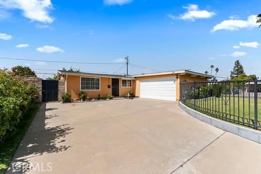 17059 E Groverdale St, Covina, CA 91722 - ranch-style house with concrete driveway, a garage, and a gate