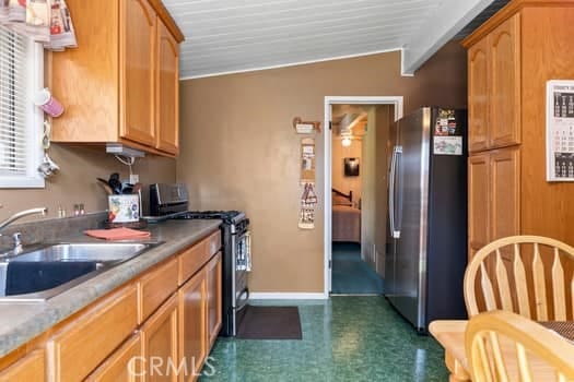 17059 E Groverdale St, Covina, CA 91722 - kitchen featuring freestanding refrigerator, gas stove, and dark floors