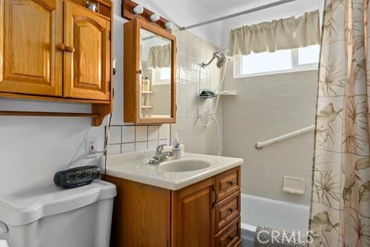 17059 E Groverdale St, Covina, CA 91722 - bathroom with shower / bath combination with curtain, vanity, and backsplash