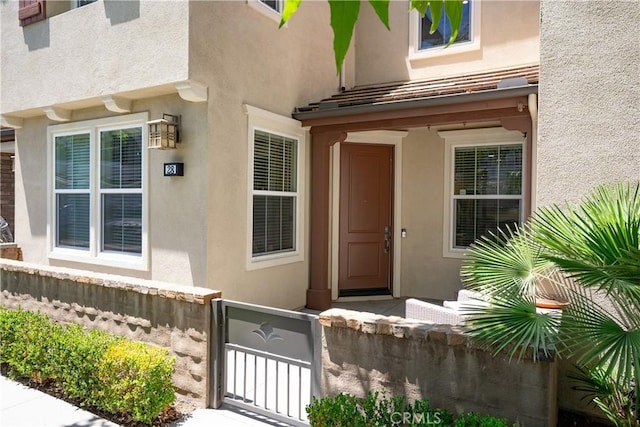 28 Sembrio St, Rancho Mission Viejo, CA 92694 - doorway to property with stucco siding and a gate