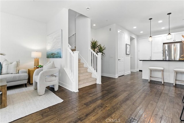 28 Sembrio St, Rancho Mission Viejo, CA 92694 - living room with dark wood-style flooring, recessed lighting, and stairs