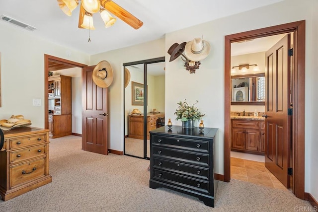 1480 Round Potrero Rd, Potrero, CA 91963 - bedroom featuring a closet, light colored carpet, connected bathroom, and a ceiling fan